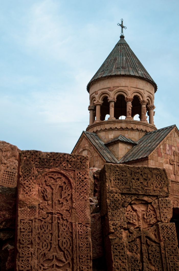 gallery-1 A serene view of the historic Noravank Monastery's architectural details against the sky.