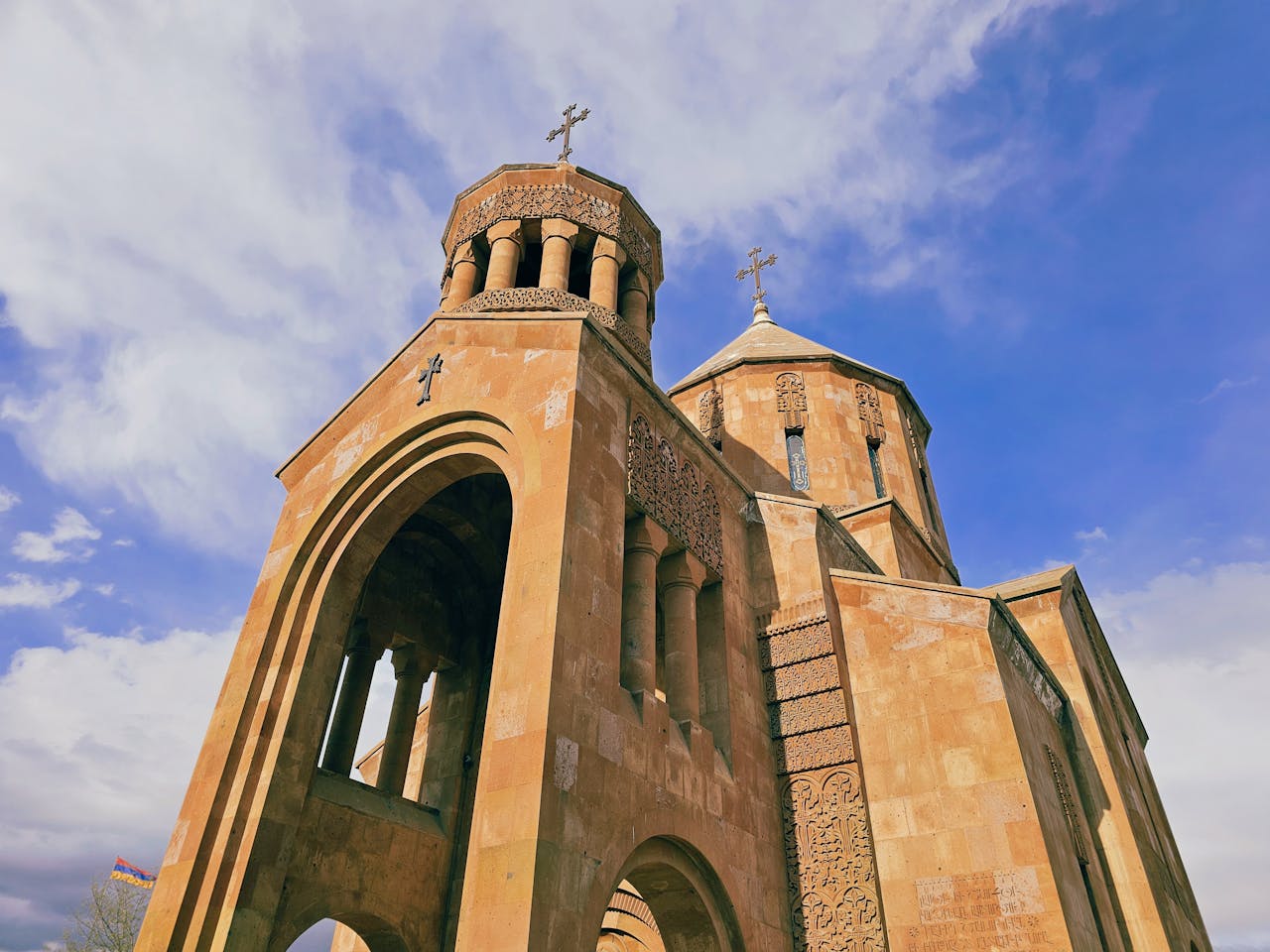 hero-img-02 Beautiful Armenian church captured against a vibrant sky in Yerevan, showcasing intricate historical architecture.