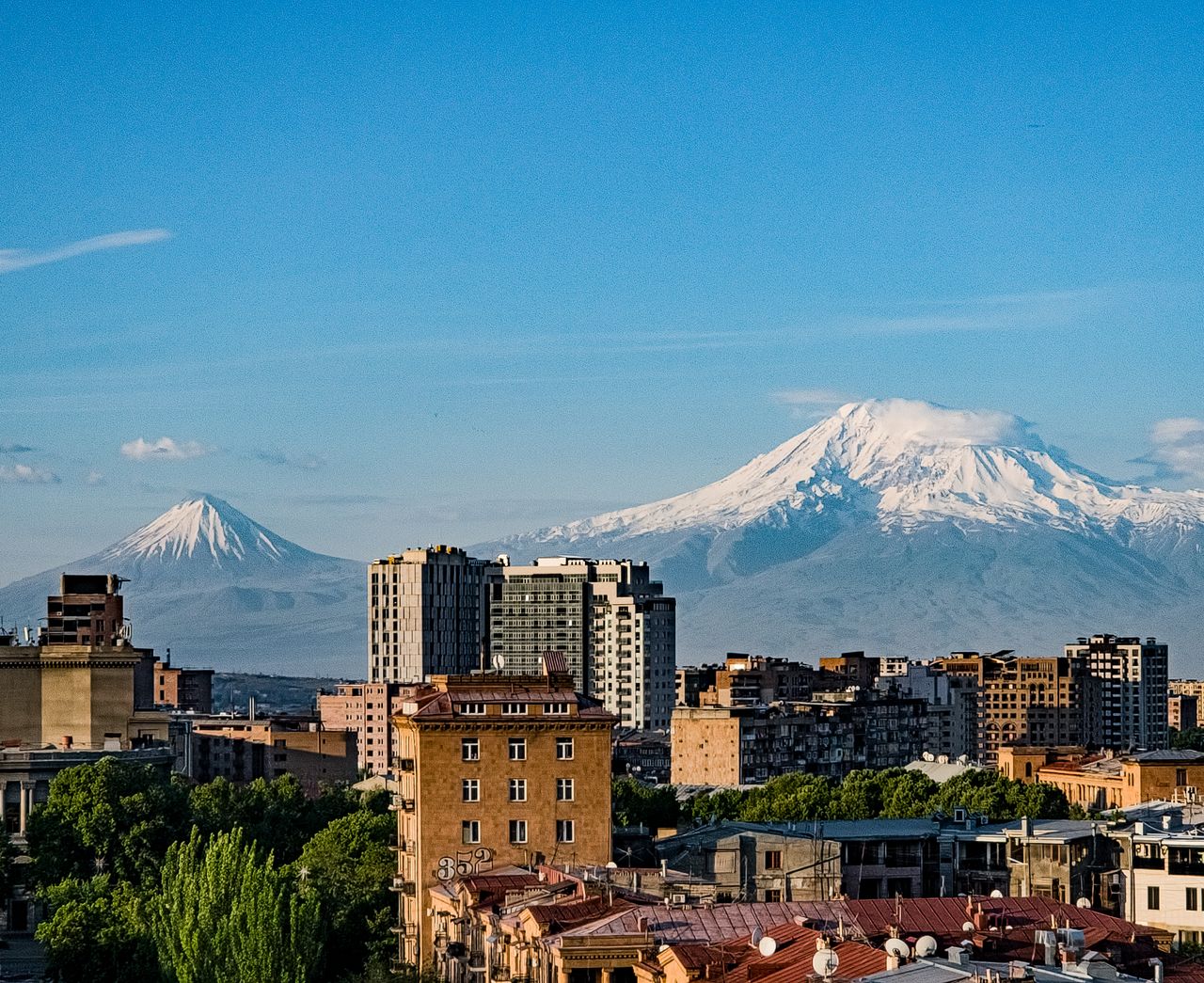 gallery-5 Breathtaking view of Yerevan city skyline with Mount Ararat in the background under a clear blue sky.