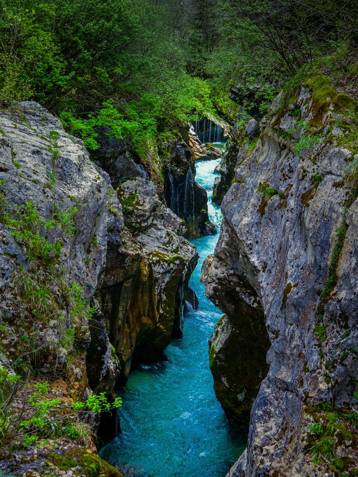 Explore the breathtaking Soča River canyon with its stunning turquoise waters and rugged cliffs in Tolmin, Slovenia.
