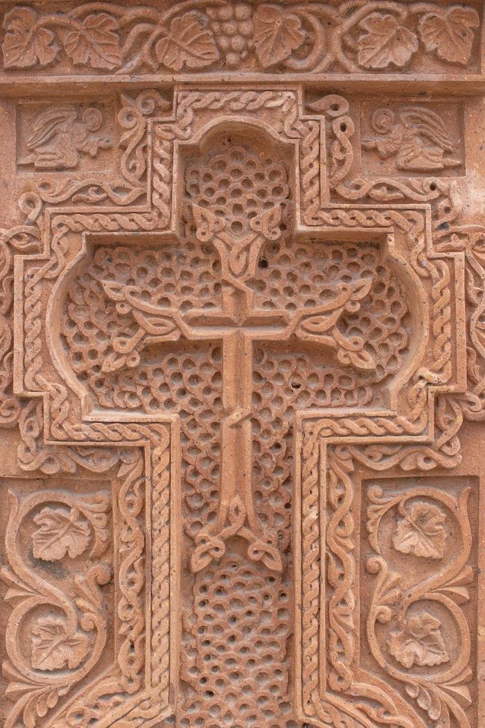 services-02 Close-up of an intricately carved Armenian khachkar, showcasing detailed craftsmanship.